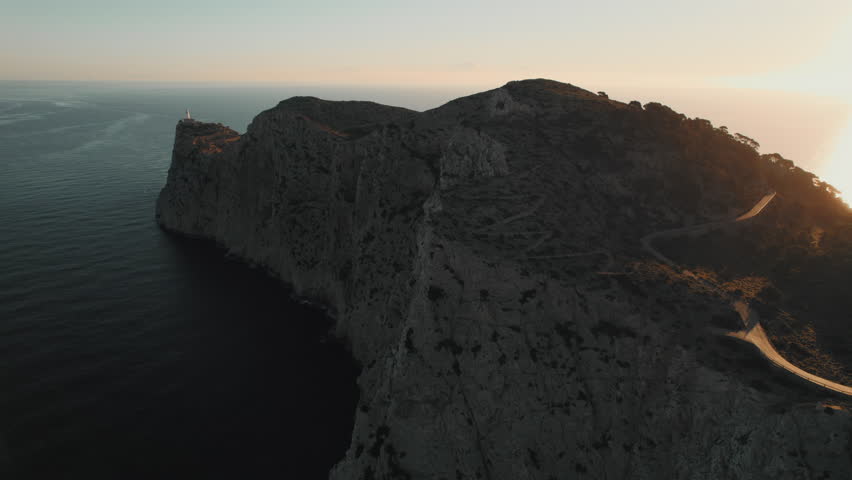 Drone point of view to The Formentor Lighthouse on rocky mountains top surrounded by waters of Mediterranean Seascape. Balearic Islands. Spain | Shutterstock HD Video #1099485205