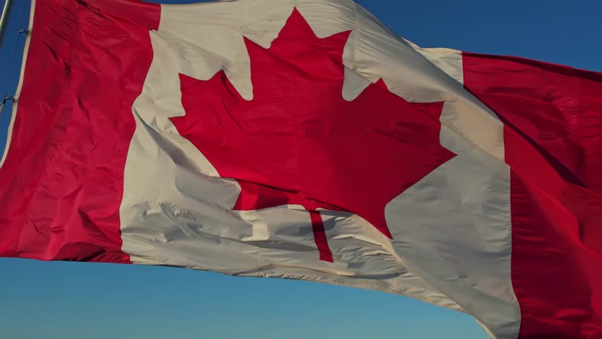 National Flag of Canada. Canadian flag slow motion at mast at Toronto city Ontario Canada in remembrance.