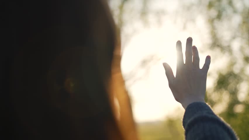 Silhouette of happy dreaming girl pulls her hand to sun.Religion helping hand. Happy girl pulls her hand.Prayer in religion.Silhouette of hand in sun.Happy girl silhouette at sunset.Freedom in nature Royalty-Free Stock Footage #1099487941