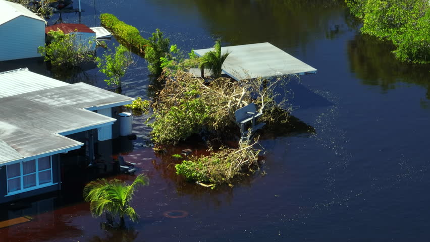 Heavy flood with high water surrounding residential house after hurricane Ian rainfall in Florida residential area. Consequences of natural disaster
