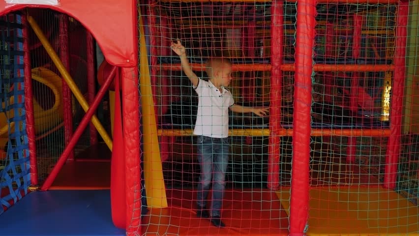 A little funny boy is playing in a children
