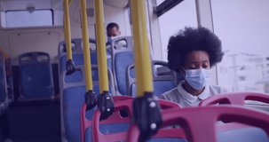 Animation of data processing over african american woman wearing face mask and using smartphone. Global pandemic, communication and digital interface concept digitally generated video.