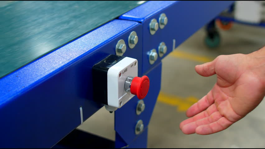 A man presses red button of conveyor belt to turn on and off the delivery of packages and boxes | Shutterstock HD Video #1099500355