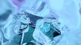 Slow motion 1000fps water liquid is poured out in blue ice cubes.Super macro slow motion 1000fps.Extreme close up pov view on blue liquid is poured out in ice cubes on camera moves inside away of us - Powered by Shutterstock - Get 15% off with code: PIKWIZARD15
