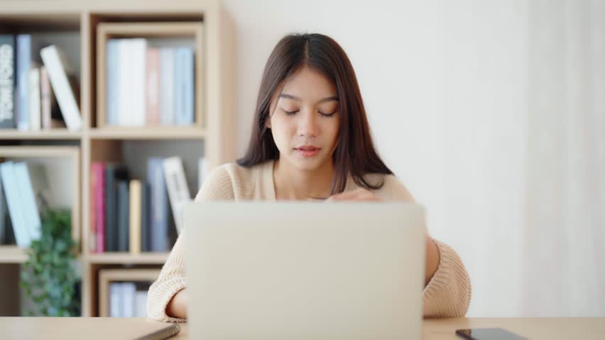 Office syndrome. Overworked tired young asian woman feeling headache, having eyesight problem after computer laptop work. Stressed young woman suffering from fatigue at home | Shutterstock HD Video #1099502405