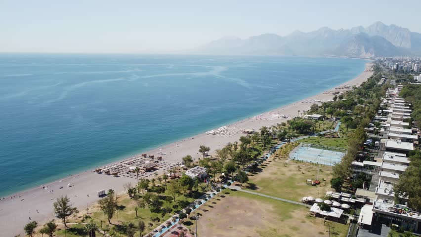 Awesome aerial view of Konyaalti Beach and Park in Antalya, Turkey. Drone flying over the beach. Konyaalti Beach is a popular tourist attraction in Turkey.