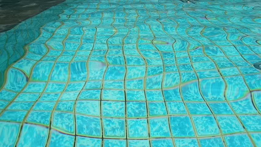 The hotel swimming pool water looks very blue, clear and fresh. | Shutterstock HD Video #1099508837