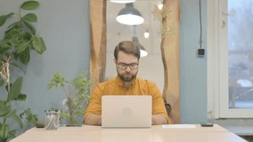 Middle Aged Businessman Smiling at Camera while using Laptop - Powered by Shutterstock - Get 15% off with code: PIKWIZARD15