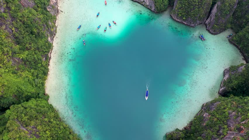 Aerial drone photo of iconic tropical turquoise water Pileh Lagoon surrounded by limestone cliffs, Phi phi islands, Thailand | Shutterstock HD Video #1099511015