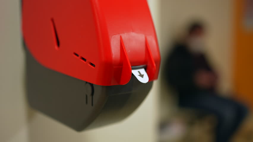 Closeup of Waiting Number Machine. Customer hand pulls a numbered ticket in dispenser machine. wait in service line | Shutterstock HD Video #1099511469