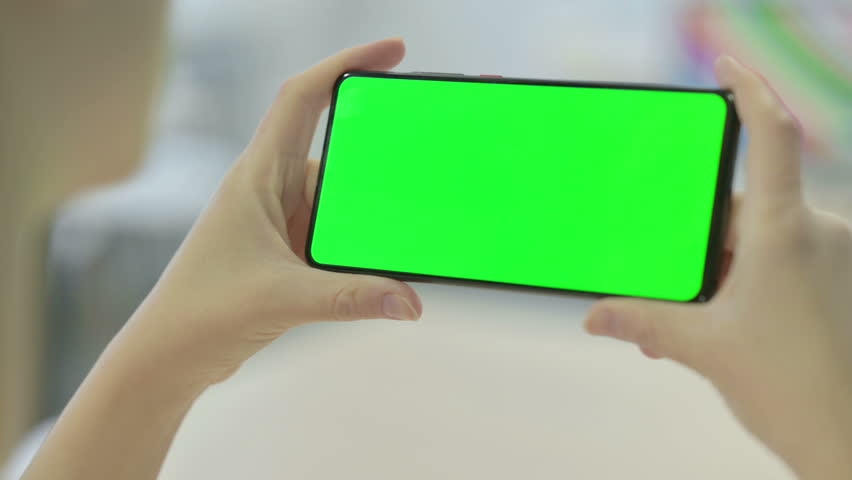 Woman Holding Smartphone with Green Screen | Shutterstock HD Video #1099511785