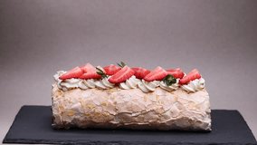 meringue roll with strawberries and powdered sugar