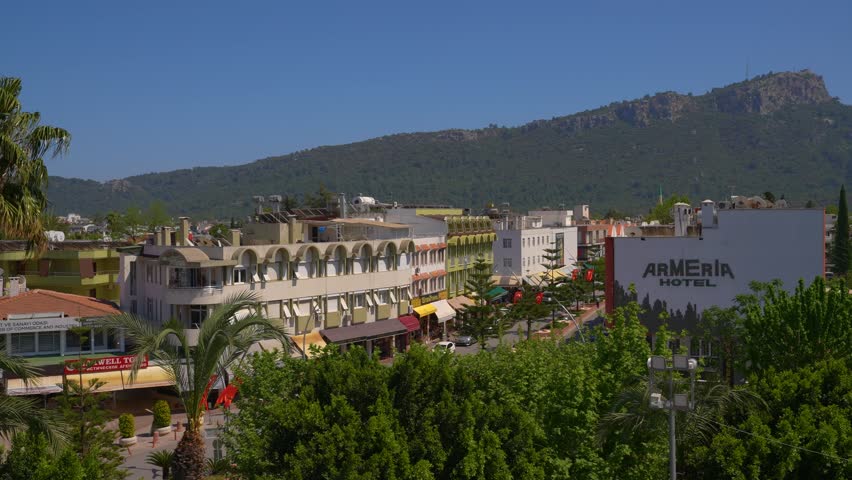 Central part of Kemer. On the background - the mountains. Kemer is a seaside resort and district of Antalya Province on the Mediterranean coast of Turkey, 43 km (27 mi) west of the city of Antalya