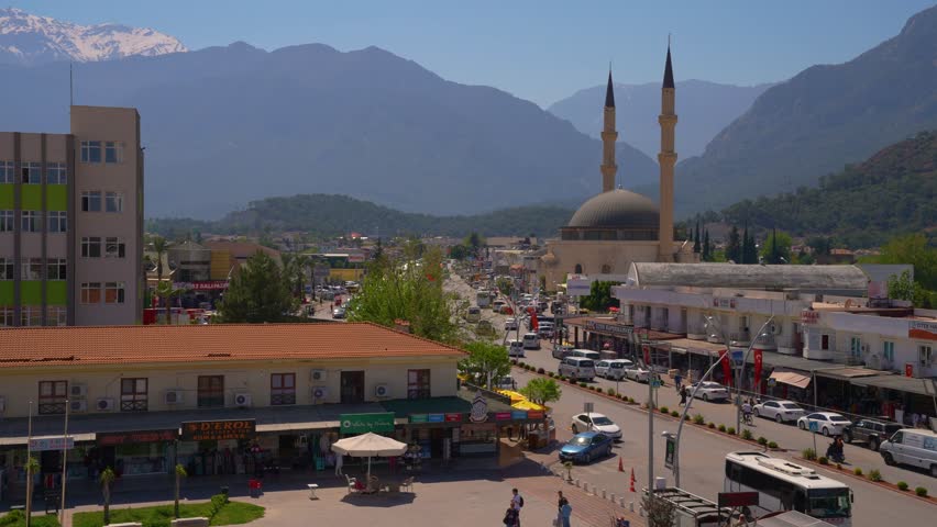 Central part of Kemer. In the foreground Dörtyol Blv. and the city mosque. In the background - the mountains. Kemer is a seaside resort and district of Antalya Province on the Mediterranean coast
