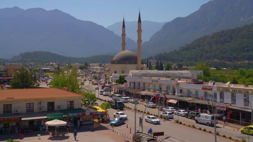 Central part of Kemer. In the foreground Dörtyol Blv. and the city mosque. In the background - the mountains. Kemer is a seaside resort and district of Antalya Province on the Mediterranean coast