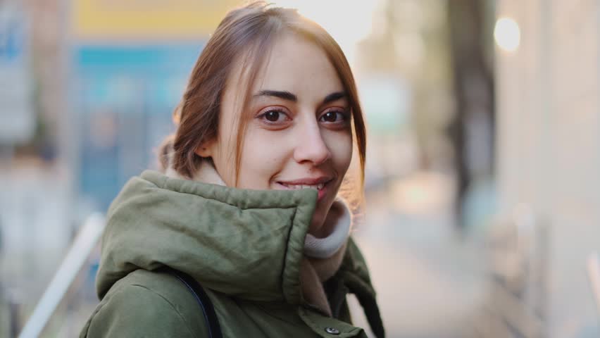 Portrait of confident young white woman looking serious at camera. Independent caucasian ukrainian female on the city background. | Shutterstock HD Video #1099514069