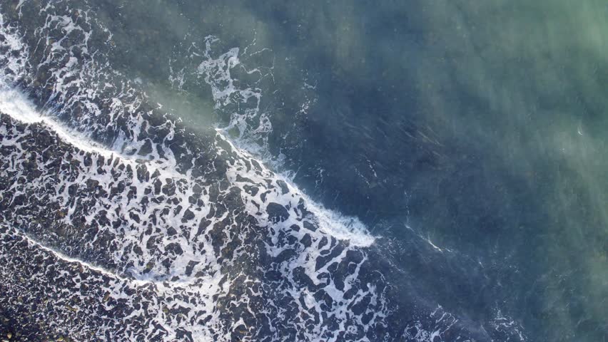 Overhead Shot Of Clear Blue Sea With Waves Splashing In Tropical North Queensland In Australia. aerial rotating | Shutterstock HD Video #1099514801