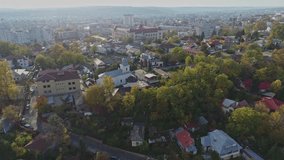 Beautiful drone view of a city with captivating mountain views on the horizon, zooming in on elaborate church