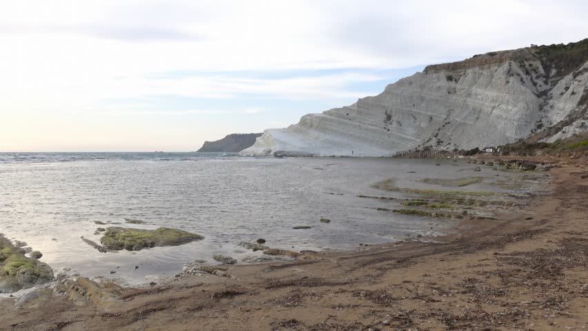 Scala dei Turchi (Stair of the Turks) in Argigento, Sicily at sunset with water waves