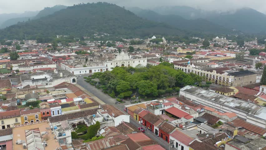 Aerial view towards the Plaza Mayor, Central Park and the Antigua Guatemala Cathedral | Shutterstock HD Video #1099516197