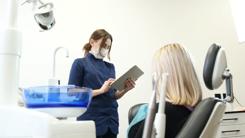 Female patient in the dental chair before dental treatment.  | Shutterstock HD Video #1099518869