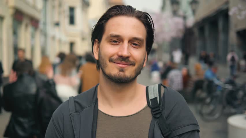 Portrait of man cheerful hipster guy dressed in trendy denim clothes smiling at camera during coffee break in touristic city.  | Shutterstock HD Video #1099521965