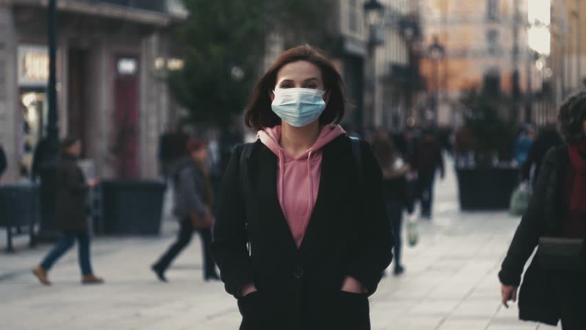 Pandemic, portrait of a young tourist woman wearing protective mask on street crowd people. the concept health and safety, N1H1 coronavirus, virus protection Royalty-Free Stock Footage #1099522033