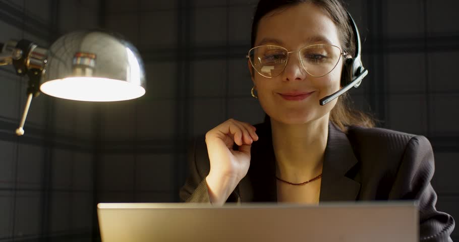 Close-up 4k video of a Caucasian woman in eyeglasses during an online video call in front of laptop monitor. | Shutterstock HD Video #1099522417