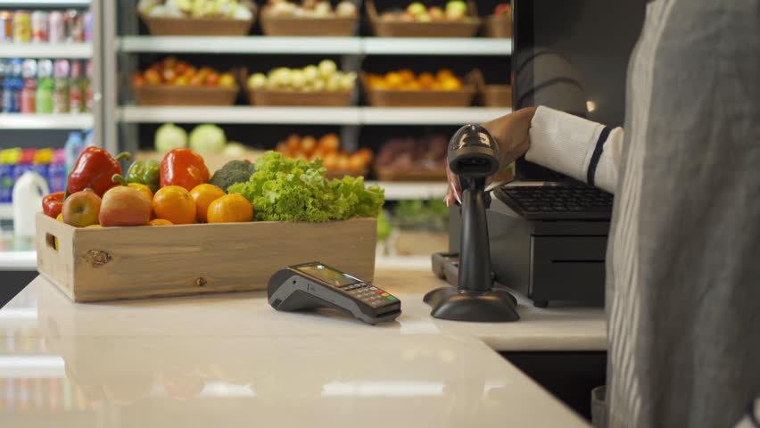 People shopping in a supermarket or retail shop, buying snacks and food by online credit card on mobile phone in cashier on grocery products shelves. Food shopping. People lifestyle.  Checkout service | Shutterstock HD Video #1099523495