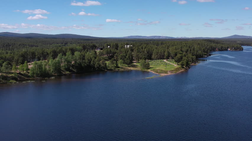 Swedish Lapland Torne River coastline, lush Poikkijarvi forest with old cemetery