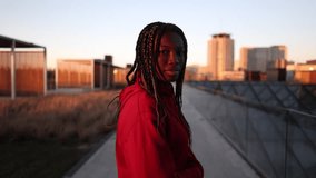 young african american woman running through the city background buildings at sunset - follow me -