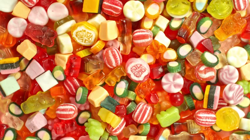 Super slow motion of flying candies up in the air. Camera in super fast motion. Filmed on high speed cinema camera, 1000 fps, placed on high speed cine bot.