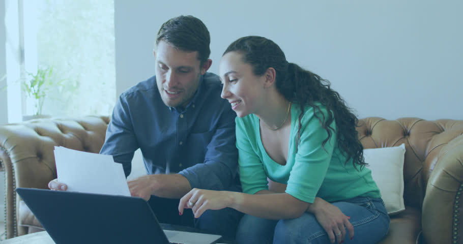 Animation of data processing over caucasian couple using laptop. Global business and digital interface concept digitally generated video.