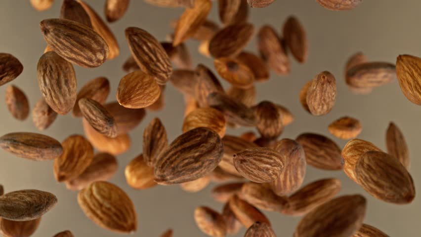 Super slow motion of rotating almonds up to the air. Filmed on high speed cinema camera, 1000fps, placed on high speed cine bot. | Shutterstock HD Video #1099526919
