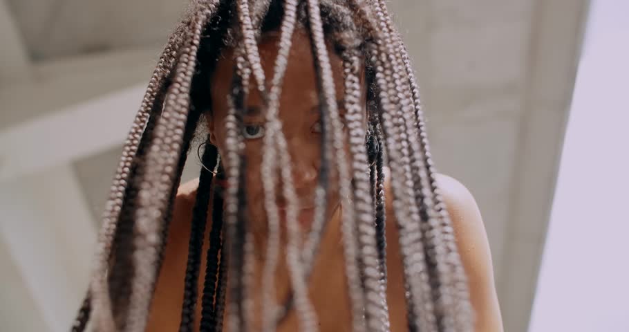 Portrait of African American with braids woman looking to the camera, 4k | Shutterstock HD Video #1099527579