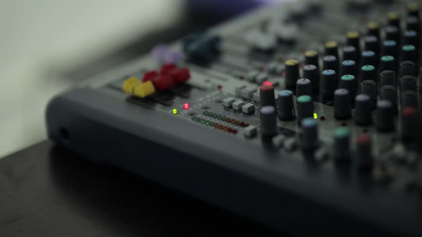 Sound engineer console close-up. Electric machine on the table for the work of a sound designer or club dj at a nightclub party. Professional tool sound engineer in the studio or at a concert. | Shutterstock HD Video #1099528355
