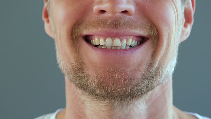 Lower part of face of bearded smiling man. White-toothed smile of handsome guy. | Shutterstock HD Video #1099529533