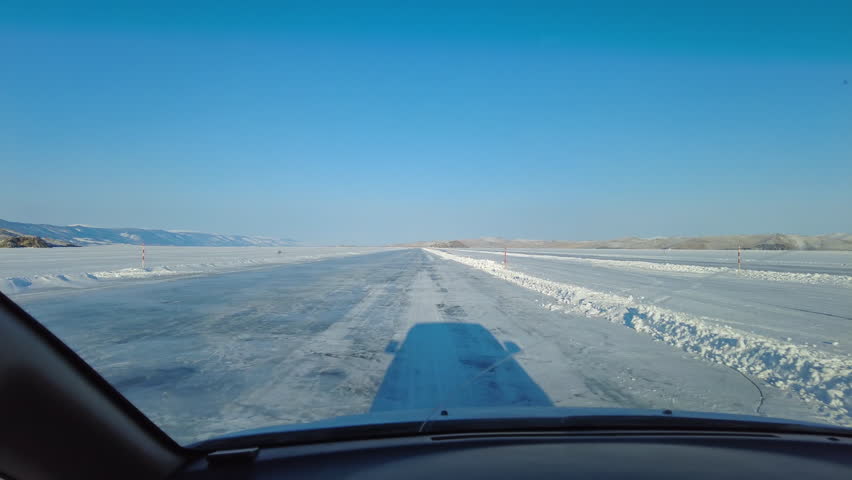 Driving on automobile road on the ice of winter Lake Baikal, Russia, 4k