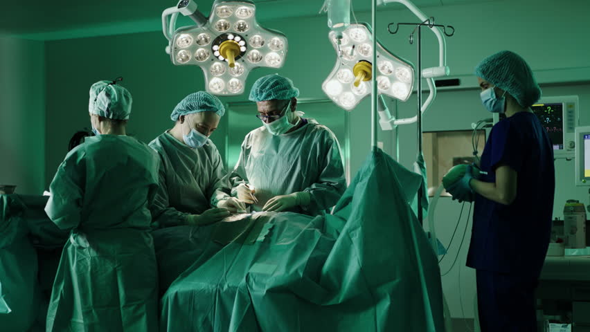 Team of proffesional doctors performing a surgery in a clinic.