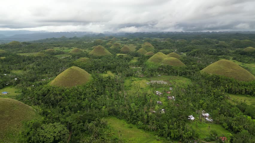 Aerial view of the beautiful numerous chocolate hills, a geological formation in the Philippine province of Bohol. The chocolate hills, which are a tourist attraction in Bohol, aerial view from above.