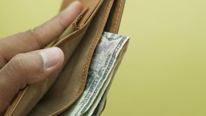 Close up of men hand taking out ash from a wallet 