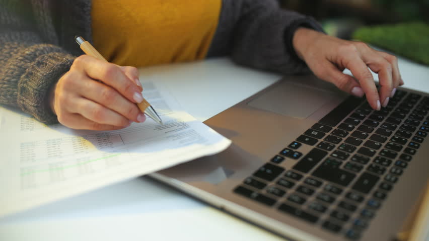 accountant woman with documents and laptop working.