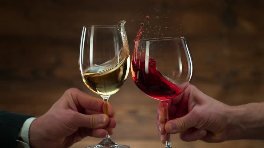 Super Slow Motion Shot of Clinking Red and White Wine at 1000fps.