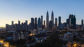 High angle aerial time lapse video of sunrise overlooking an urban village against Kuala Lumpur city skyline in KL Malaysia. High quality, Prores Full HD Timelapse.