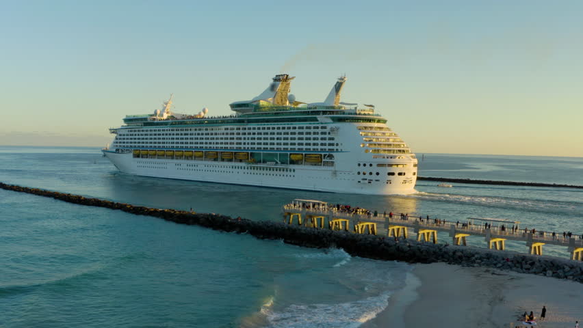 Cruise Ship At Port Miami At Miami Florida United States. Ships and cruise liners at the pier. Huge cruise ship leaving Port of Miami at sunset, USA. Cruise ship from above with Drone. 