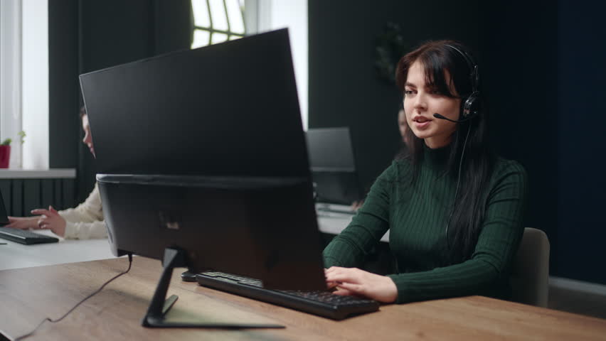 young woman works in call-center or telesales department, answering customer calls