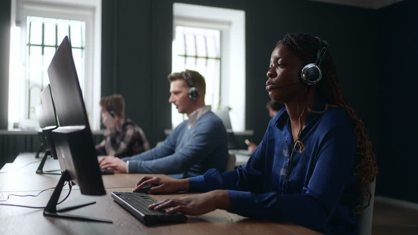 diverse workers of call-center, black woman consulting customer by phone, portrait in office