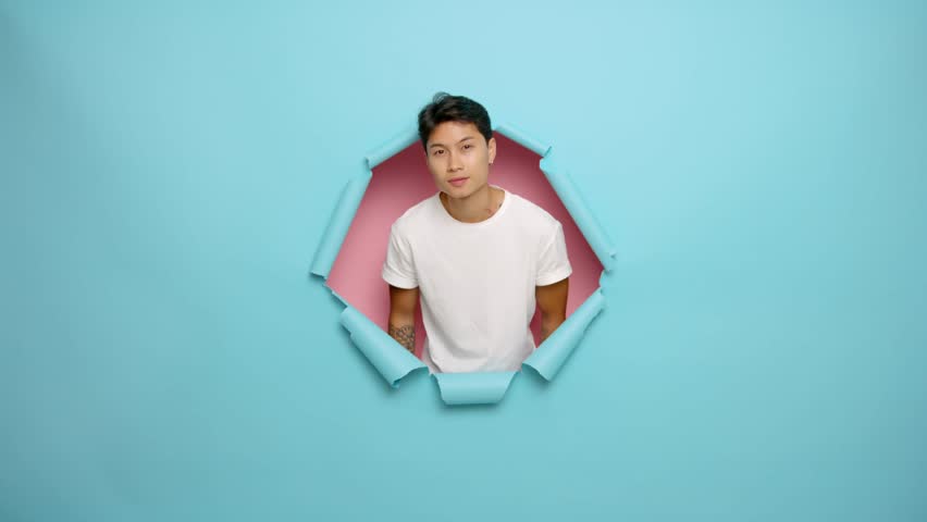 Photo of satisfied Asian man with toothy smile show thumb up wear white t-shirt, isolated on blue and pink color background | Shutterstock HD Video #1099549219