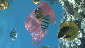 VERTICAL VIDEO, Close-up of the red plastic shopping bag slowly swims with school of colorful tropical fish near a coral reef in blue water. Plastic pollution of the Ocean. Slow motion