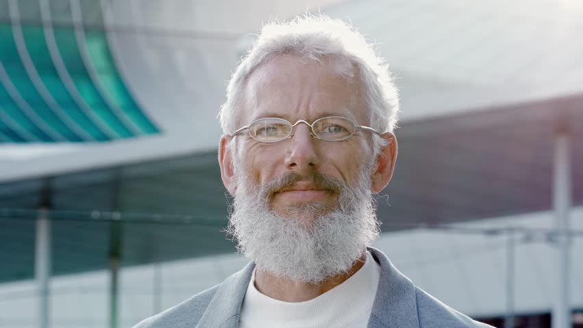 Smiling happy mature older bearded business man leader, smiling middle aged senior professional businessman ceo wearing suit and glasses laughing looking at camera outside, headshot portrait. | Shutterstock HD Video #1099556501